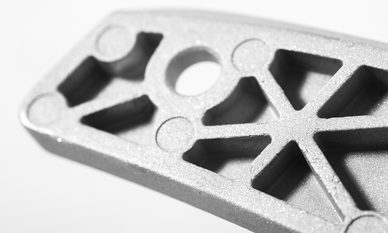 Precision Die-Cast Zamak & Aluminum Components | Bruschi Close-up of a precision die-cast aluminum component, showcasing the intricate detail and high-quality finish produced by Bruschi. Illustrative of Bruschi's expertise in Zamak and aluminum die-casting.