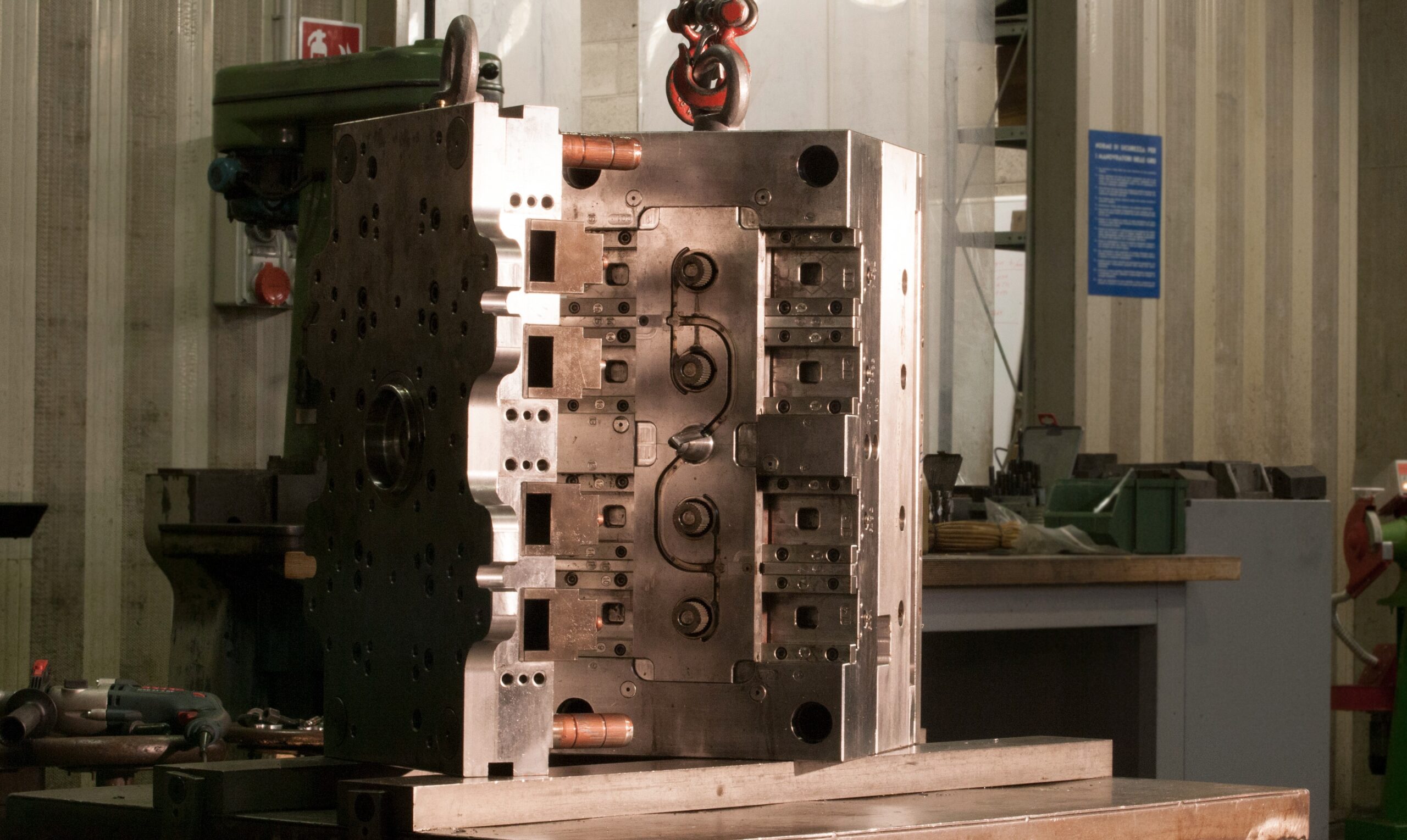 Close-up of a large, intricate die-casting mold used by Bruschi for the precision manufacturing of zinc (zamak) and aluminum components. The image highlights the company's expertise in high-quality metal die casting.