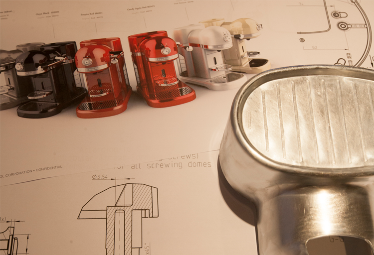 High-quality die-cast zinc (zamak) and aluminum components manufactured by Bruschi. Image showcases finished espresso machine parts in various colors alongside detailed engineering drawings. Illustrates Bruschi's expertise in precision die-casting for the appliance industry.